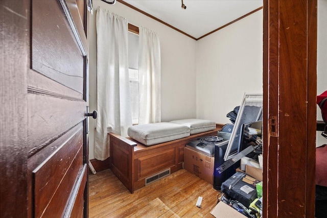 bedroom featuring light wood-type flooring and ornamental molding