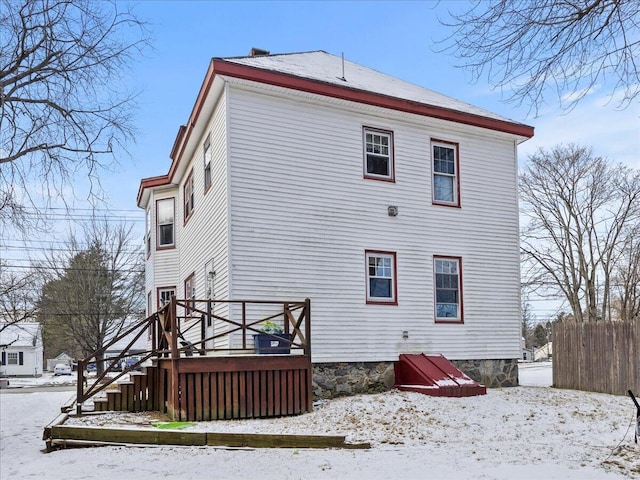 view of snow covered back of property