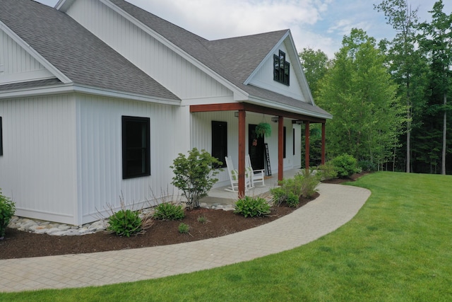 view of home's exterior featuring a yard and covered porch