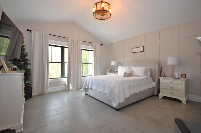 bedroom featuring a chandelier and vaulted ceiling