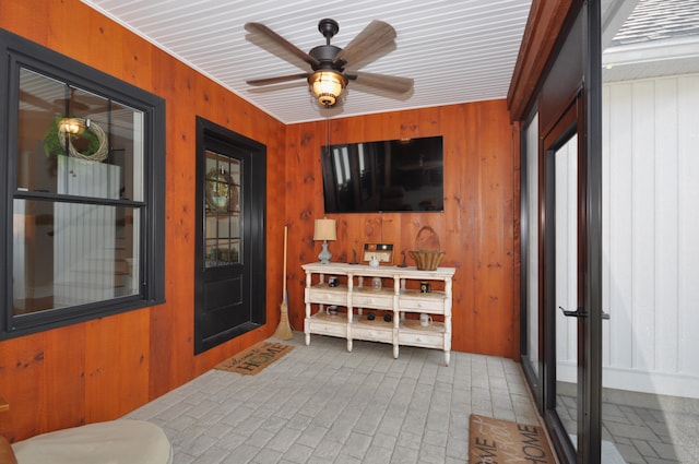 sunroom featuring ceiling fan