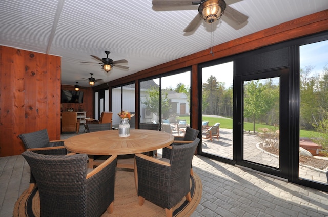 sunroom featuring ceiling fan