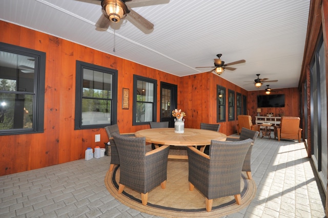 interior space with ceiling fan