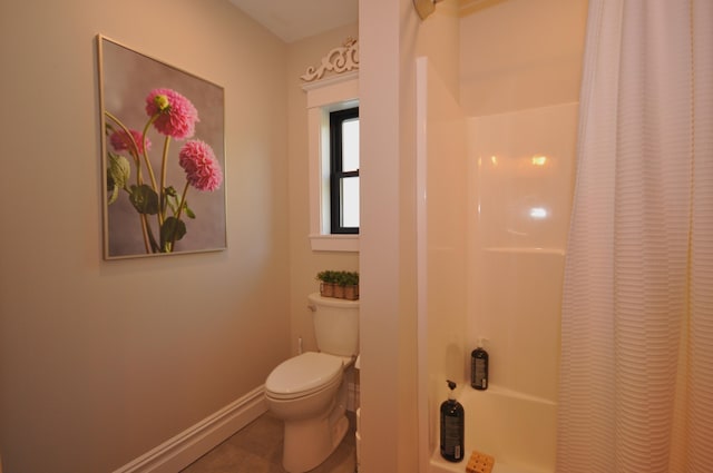 bathroom with tile patterned flooring, a shower with curtain, and toilet