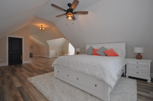 bedroom featuring dark hardwood / wood-style floors, ceiling fan, and lofted ceiling