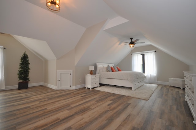 bedroom with ceiling fan, dark hardwood / wood-style flooring, and vaulted ceiling