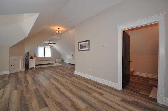 bonus room featuring dark hardwood / wood-style flooring, ceiling fan, and lofted ceiling