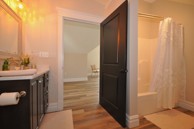 bathroom featuring shower / bath combo with shower curtain, vanity, and hardwood / wood-style flooring