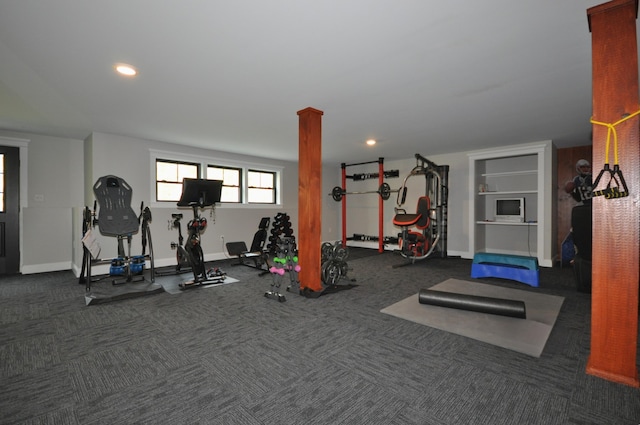 gym with dark carpet and ornate columns