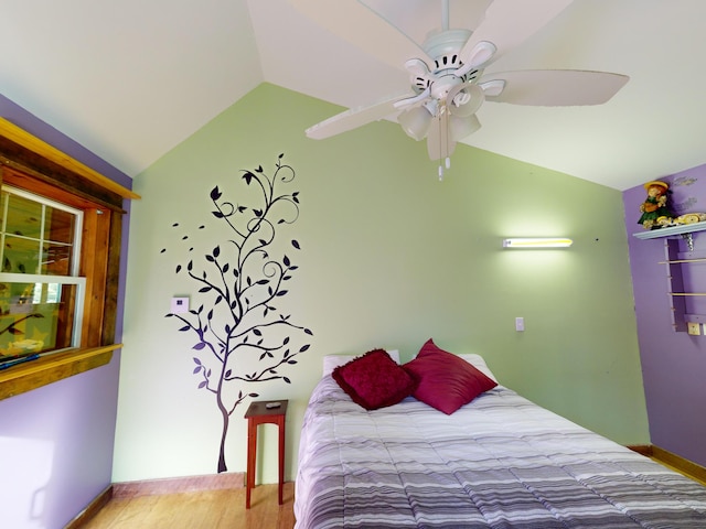 bedroom featuring lofted ceiling, wood-type flooring, and ceiling fan