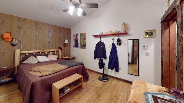 bedroom featuring ceiling fan, lofted ceiling, and hardwood / wood-style floors