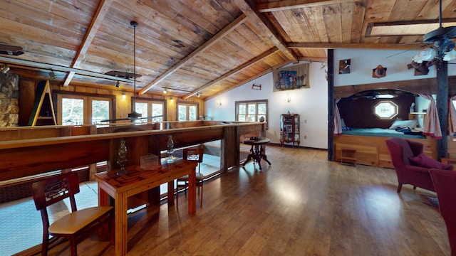 dining space featuring hardwood / wood-style flooring, vaulted ceiling with beams, and wooden ceiling