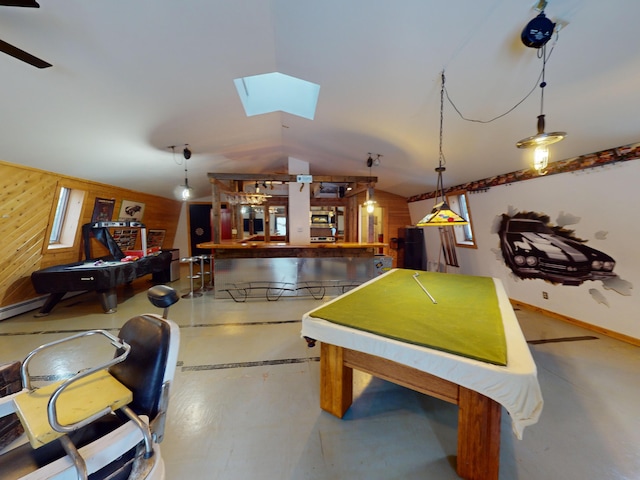 playroom with a baseboard radiator, vaulted ceiling with skylight, and wooden walls