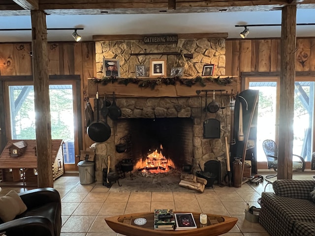 tiled living room with a fireplace and wooden walls