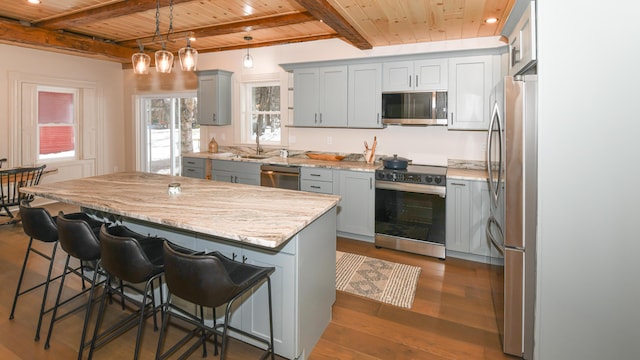 20 N High St, Bridgton, ME 04009 - kitchen featuring a center island, hanging light fixtures, dark hardwood / wood-style floors, wood ceiling, and appliances with stainless steel finishes