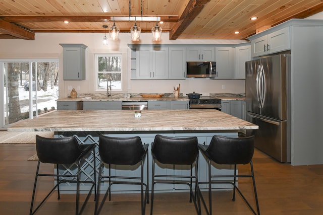 20 N High St, Bridgton, ME 04009 - kitchen featuring beam ceiling, a kitchen island, and appliances with stainless steel finishes