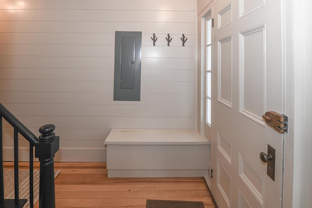 20 N High St, Bridgton, ME 04009 - mudroom featuring light wood-type flooring, electric panel, and wooden walls