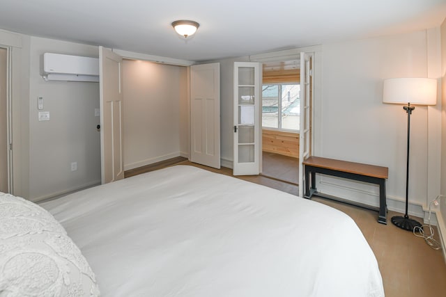 20 N High St, Bridgton, ME 04009 - bedroom with a wall mounted AC and hardwood / wood-style floors