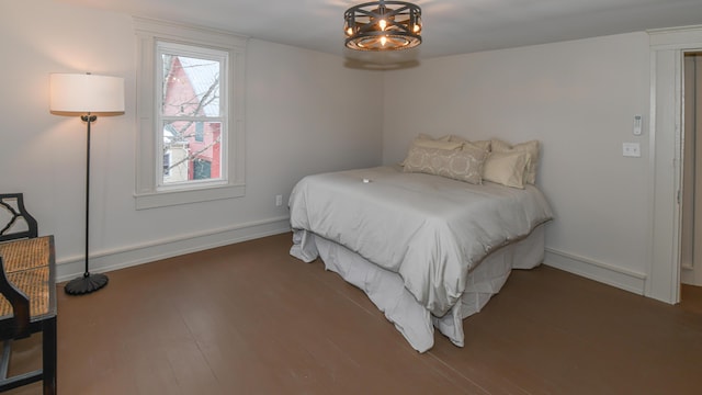 20 N High St, Bridgton, ME 04009 - bedroom with dark hardwood / wood-style floors and a notable chandelier