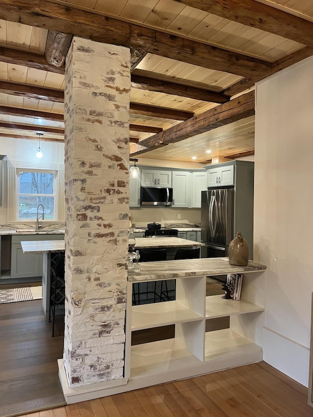 20 N High St, Bridgton, ME 04009 - kitchen featuring a kitchen breakfast bar, beamed ceiling, wood-type flooring, stainless steel appliances, and wood ceiling