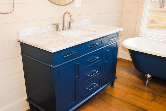 20 N High St, Bridgton, ME 04009 - bathroom featuring a washtub, wood-type flooring, and vanity
