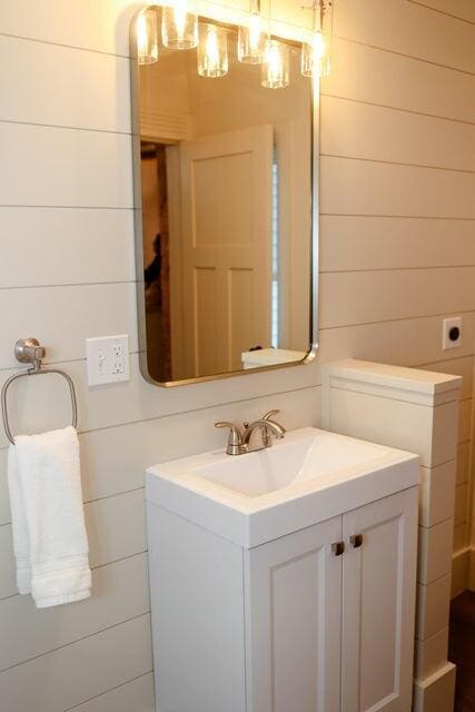 20 N High St, Bridgton, ME 04009 - bathroom featuring wooden walls and vanity