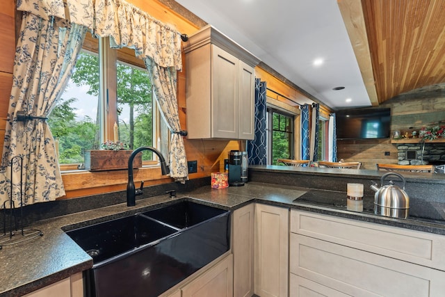 18 Severin Way, Limerick, ME 04048 - kitchen with black electric cooktop, dark stone countertops, recessed lighting, and wooden walls