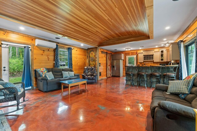18 Severin Way, Limerick, ME 04048 - living area featuring a wall unit AC, concrete floors, recessed lighting, wooden walls, and wood ceiling