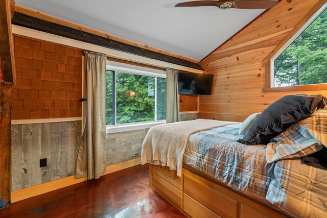 18 Severin Way, Limerick, ME 04048 - bedroom featuring lofted ceiling, multiple windows, wood walls, ceiling fan, and finished concrete floors