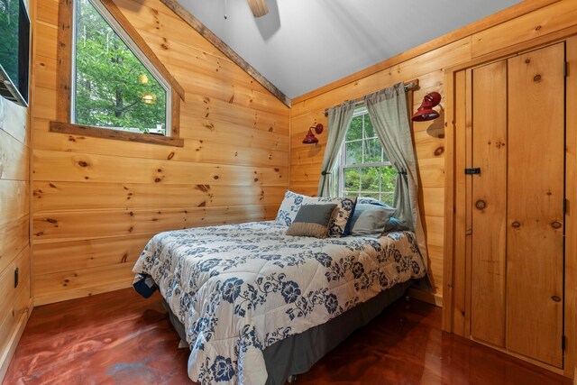 18 Severin Way, Limerick, ME 04048 - bedroom with vaulted ceiling, wooden walls, dark wood-style flooring, and ceiling fan