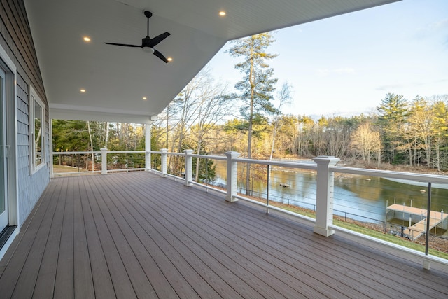 wooden deck with ceiling fan and a water view