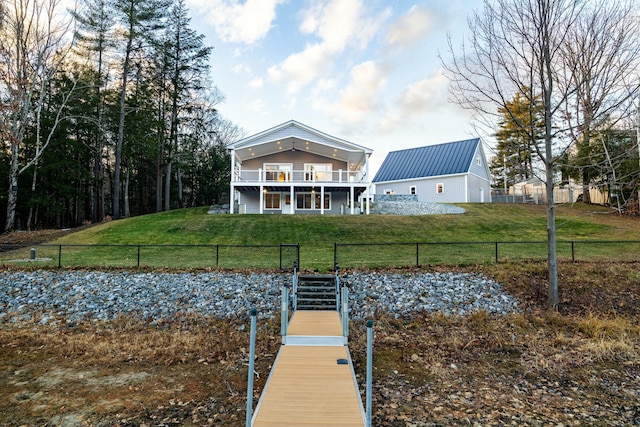 rear view of property with a yard