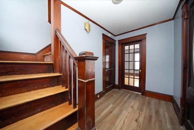 interior space featuring french doors, light hardwood / wood-style floors, and crown molding