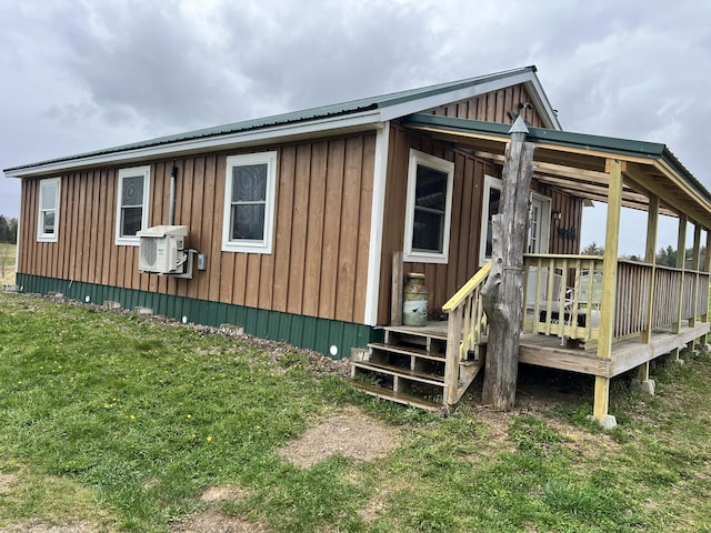 view of property exterior with a lawn and a wooden deck