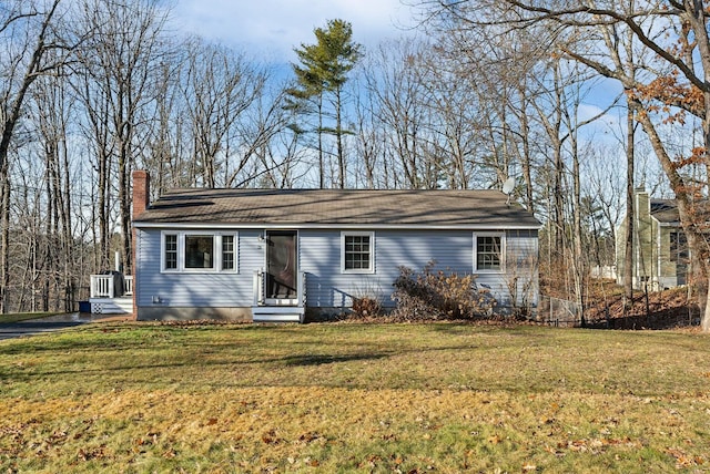 ranch-style home with a front yard and central AC