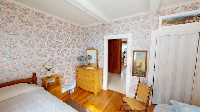 90 E Ter, Millinocket, ME 04462 - bedroom with light wood-type flooring, beamed ceiling, wallpapered walls, a closet, and ornamental molding