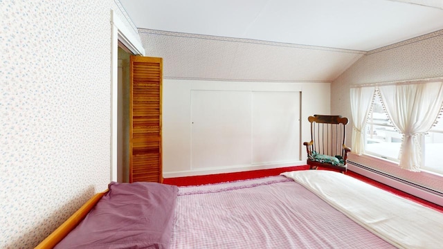 90 E Ter, Millinocket, ME 04462 - bedroom featuring wallpapered walls, vaulted ceiling, a baseboard radiator, and a closet