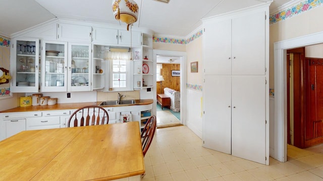 90 E Ter, Millinocket, ME 04462 - kitchen featuring a sink, white cabinets, open shelves, crown molding, and glass insert cabinets