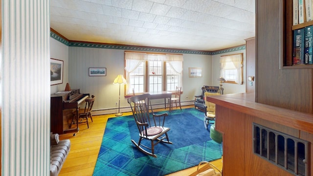90 E Ter, Millinocket, ME 04462 - living area with hardwood / wood-style floors, a baseboard heating unit, and ornamental molding