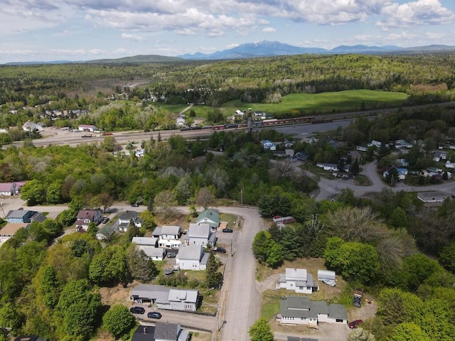 90 E Ter, Millinocket, ME 04462 - aerial view of property and surrounding area with a mountain backdrop, a forest, and nearby suburban area