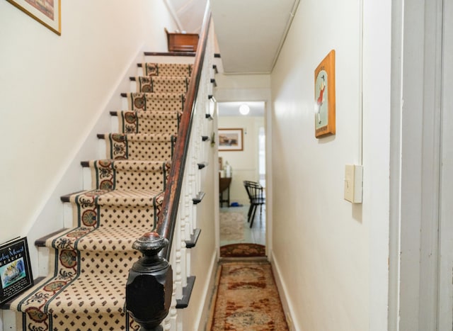 stairway featuring crown molding