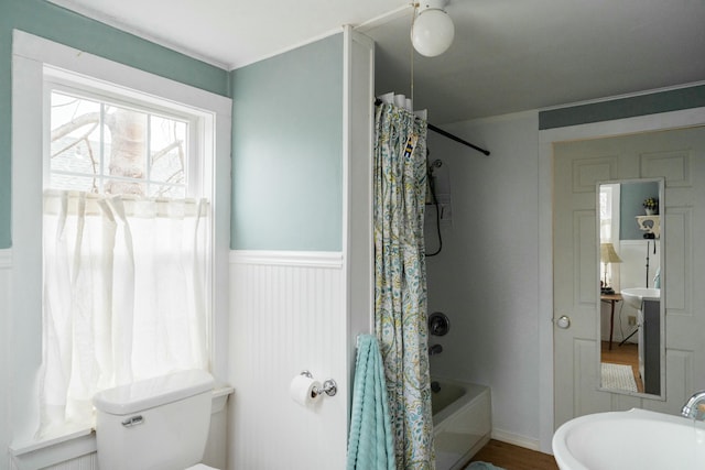 full bathroom featuring hardwood / wood-style floors, toilet, shower / bath combo with shower curtain, and sink