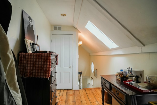 bonus room featuring light wood-type flooring and lofted ceiling with skylight