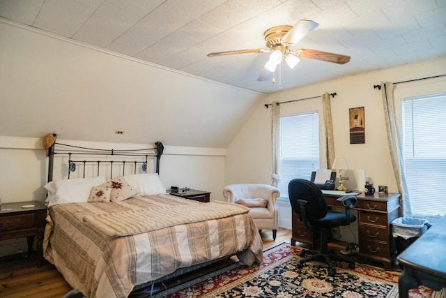 bedroom with ceiling fan, wood-type flooring, multiple windows, and vaulted ceiling