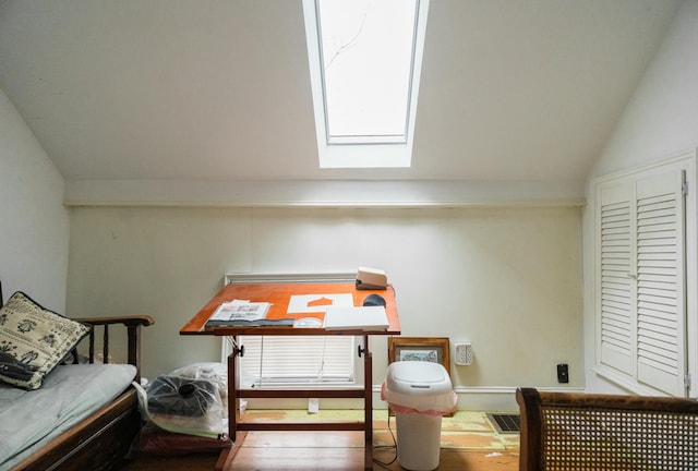 living area featuring vaulted ceiling with skylight and wood-type flooring