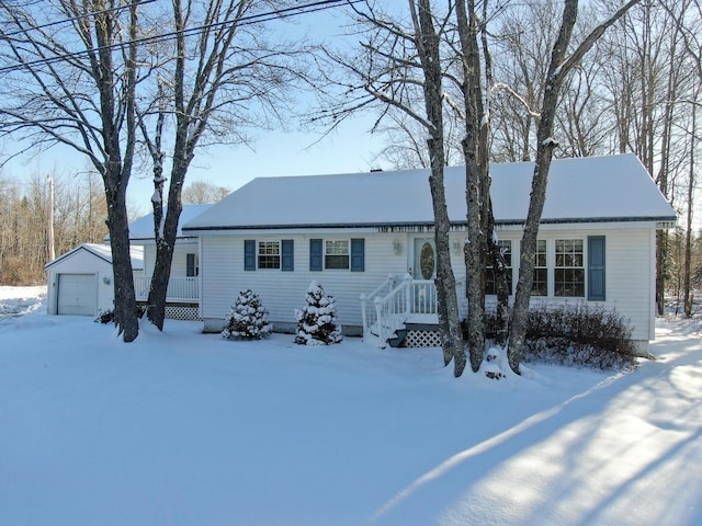 view of front of home featuring a garage and an outdoor structure