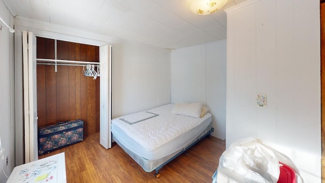 bedroom with a closet and hardwood / wood-style floors