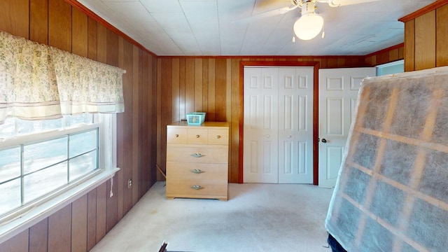 carpeted bedroom with ceiling fan and a closet