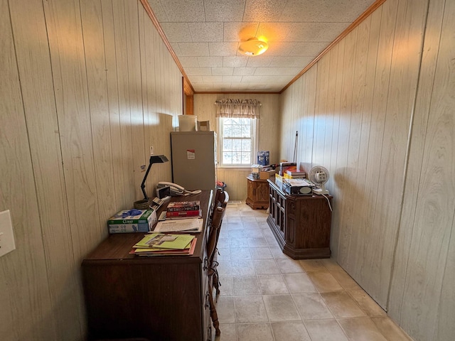 office space with crown molding and wooden walls