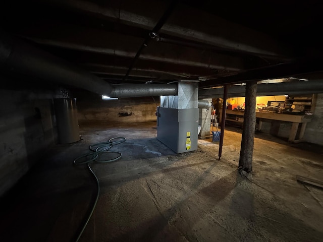 basement featuring heating unit and gas water heater